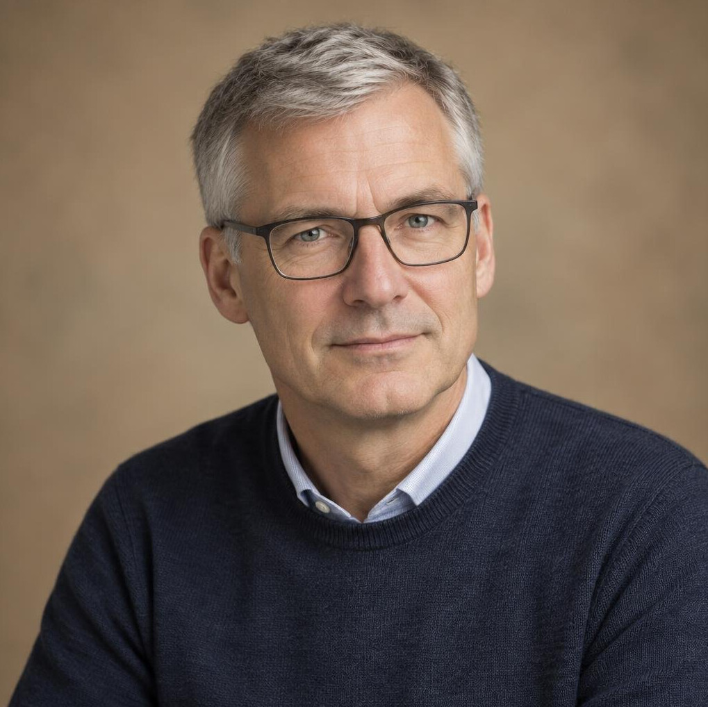 Studio portrait of a German man in his fifties with glasses